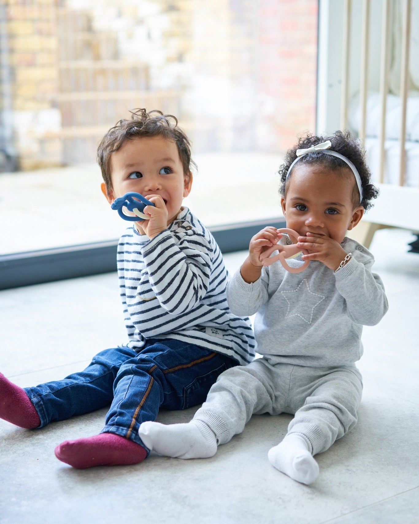 two kids with teethers
