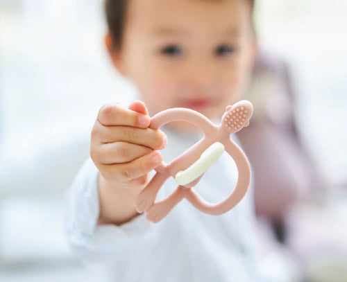 baby with pink matchstick monkey
